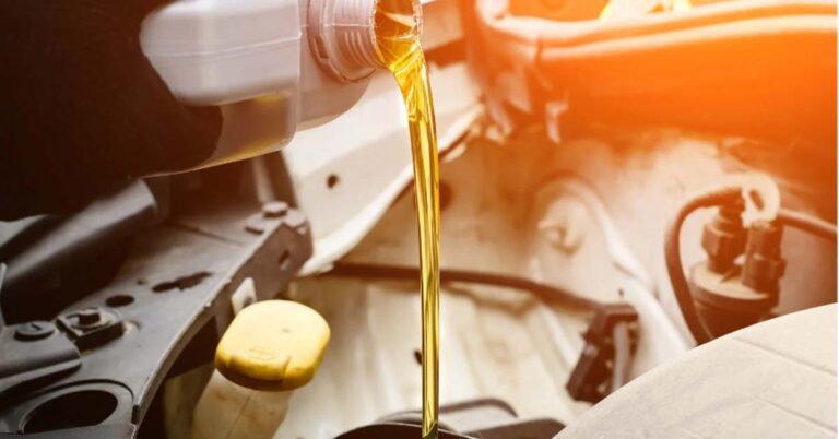 A Pouring Oil Into A Car